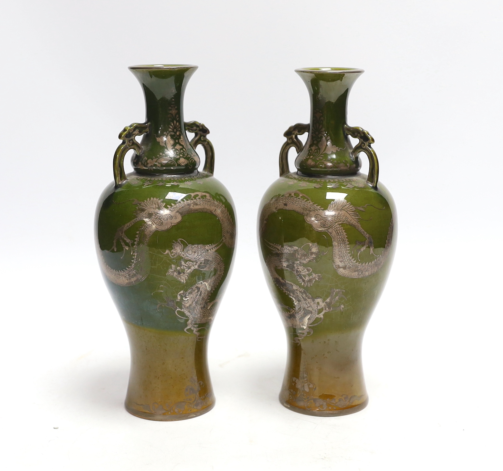 A pair of Japanese silver lustre decorated ‘dragon’ vases, 22.5cm